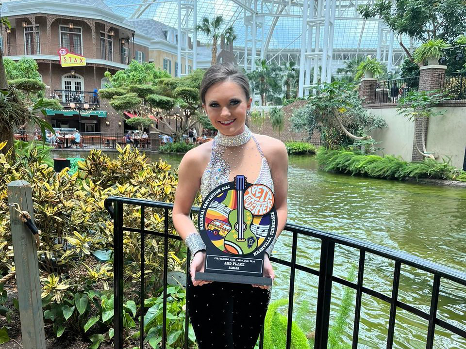 Chloe holding award